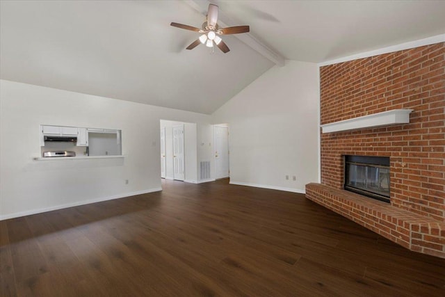 910 Garwood St, Smithville, TX 78957 - unfurnished living room featuring ceiling fan, dark wood-type flooring, and a fireplace