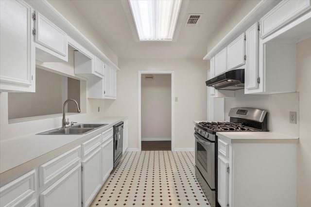 910 Garwood St, Smithville, TX 78957 - kitchen with stainless steel range with gas cooktop, under cabinet range hood, dishwasher, and light countertops