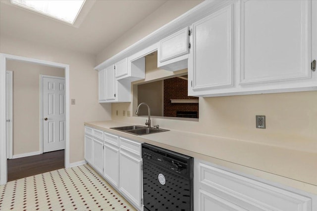 910 Garwood St, Smithville, TX 78957 - kitchen featuring dishwasher, light countertops, and white cabinets