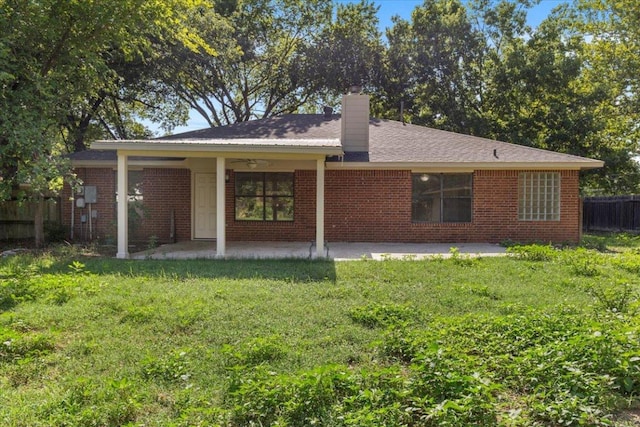 910 Garwood St, Smithville, TX 78957 - rear view of property with a patio area, brick siding, a chimney, and ceiling fan