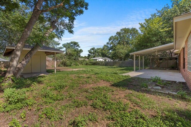 910 Garwood St, Smithville, TX 78957 - fenced backyard featuring a patio and a shed