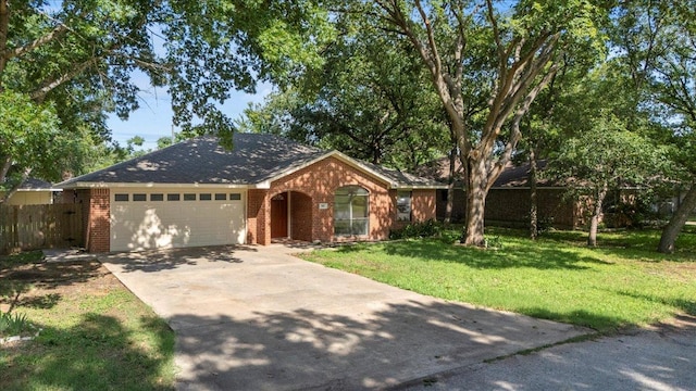 910 Garwood St, Smithville, TX 78957 - ranch-style home with an attached garage, concrete driveway, and brick siding
