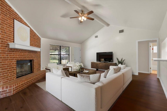 910 Garwood St, Smithville, TX 78957 - living room featuring a fireplace, dark wood-type flooring, beam ceiling, a ceiling fan, and high vaulted ceiling
