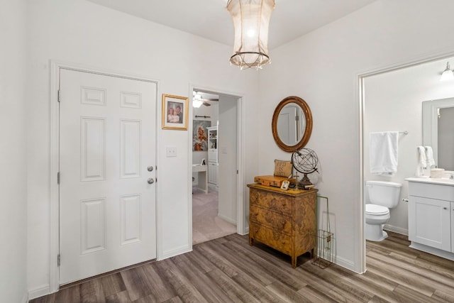 121 Rubrum Rd, Kyle, TX 78640 - entrance foyer with wood finished floors, a chandelier, and a ceiling fan
