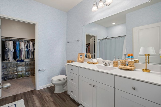 121 Rubrum Rd, Kyle, TX 78640 - full bathroom featuring wood finished floors, vanity, a walk in closet, and curtained shower