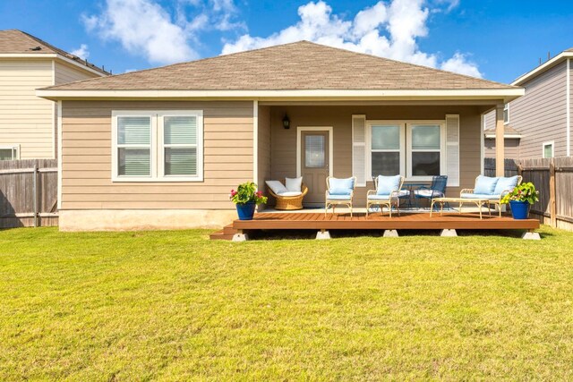 121 Rubrum Rd, Kyle, TX 78640 - back of property with a fenced backyard, outdoor lounge area, and a wooden deck