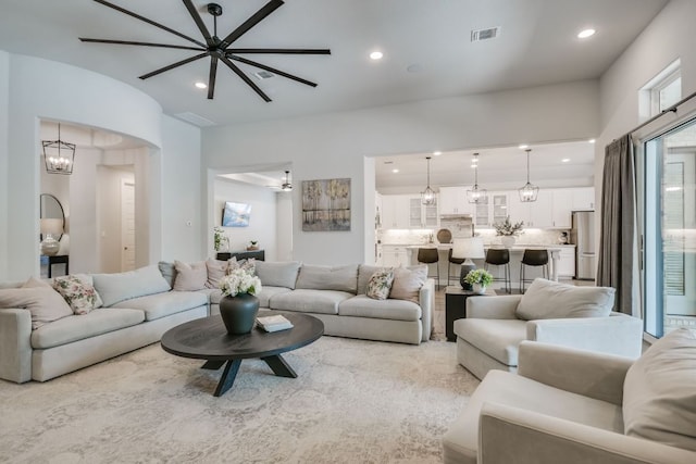 206 Bridge Water Loop, Dripping Springs, TX 78620 - living room featuring recessed lighting, a chandelier, and arched walkways