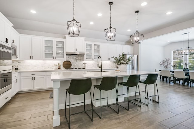 206 Bridge Water Loop, Dripping Springs, TX 78620 - kitchen featuring a sink, stainless steel appliances, under cabinet range hood, backsplash, and recessed lighting