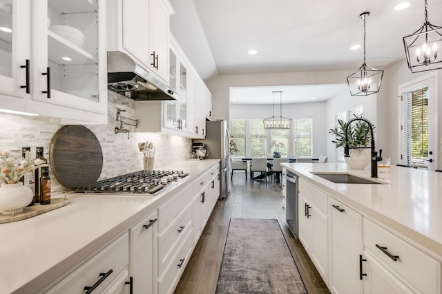 206 Bridge Water Loop, Dripping Springs, TX 78620 - kitchen with a chandelier, a sink, under cabinet range hood, stainless steel appliances, and light countertops