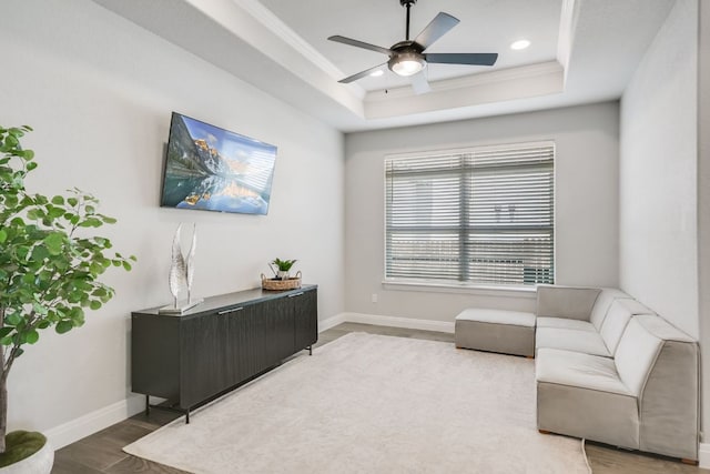 206 Bridge Water Loop, Dripping Springs, TX 78620 - living area with a tray ceiling, wood finished floors, baseboards, ceiling fan, and ornamental molding