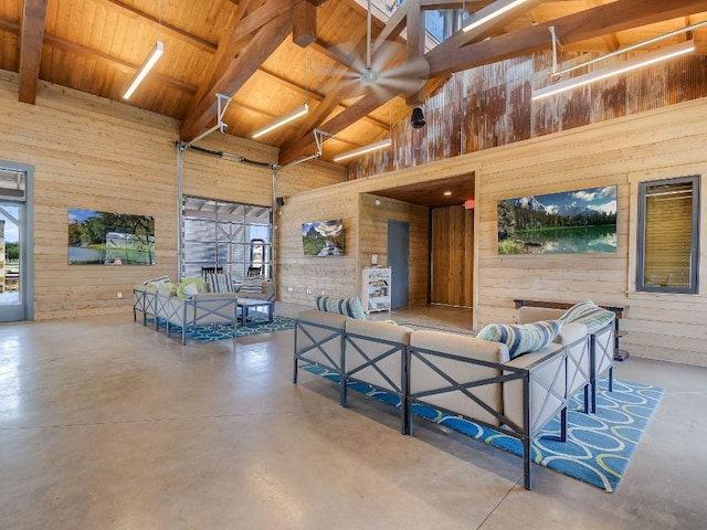 206 Bridge Water Loop, Dripping Springs, TX 78620 - living area with high vaulted ceiling, finished concrete floors, wood walls, and wood ceiling with exposed beams