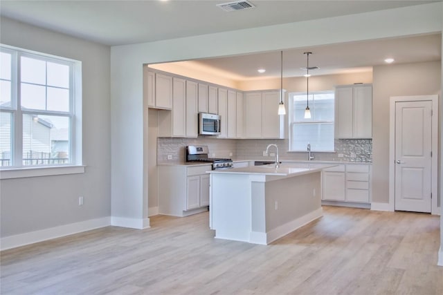 5907 Rotunda Vw, Austin, TX 78747 - kitchen featuring appliances with stainless steel finishes, healthy amount of natural light, tasteful backsplash, and recessed lighting