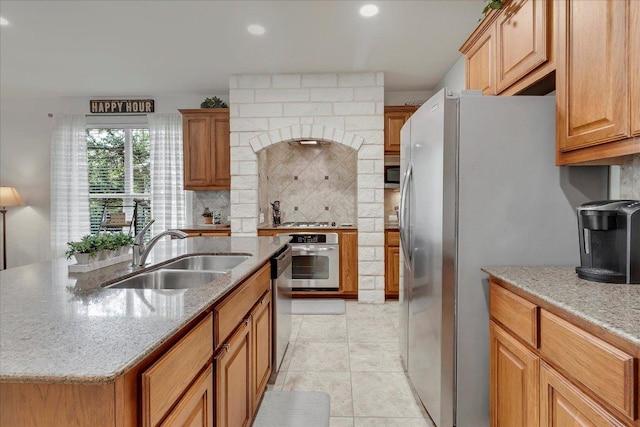 167 Limestone Trl Unit 76, Austin, TX 78737 - kitchen with appliances with stainless steel finishes, a sink, tasteful backsplash, recessed lighting, and light stone counters