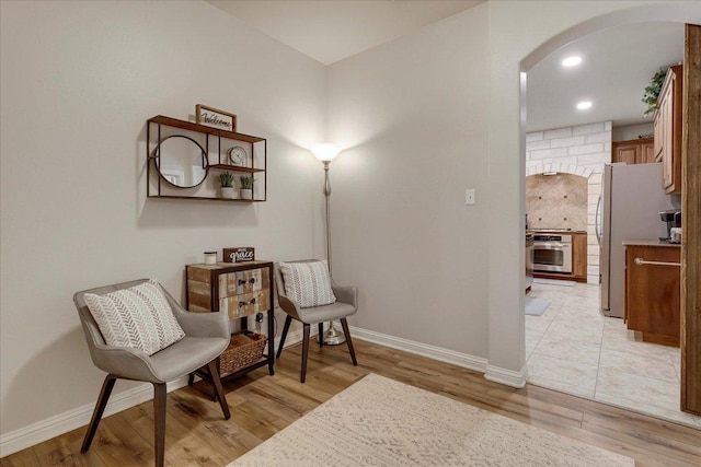167 Limestone Trl Unit 76, Austin, TX 78737 - sitting room with arched walkways, light wood-style floors, baseboards, and recessed lighting