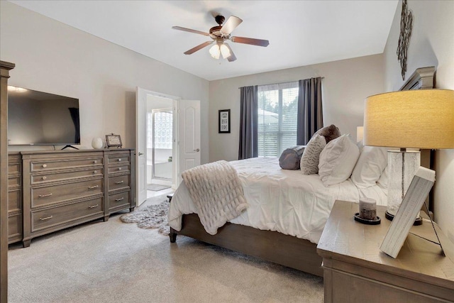 167 Limestone Trl Unit 76, Austin, TX 78737 - bedroom featuring light carpet, a ceiling fan, and ensuite bath