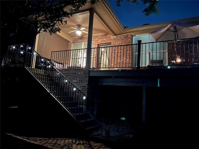 167 Limestone Trl Unit 76, Austin, TX 78737 - property exterior at night featuring stairs, brick siding, and ceiling fan