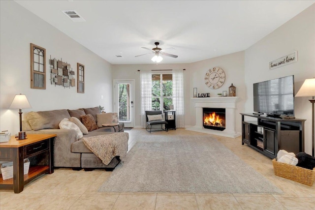 167 Limestone Trl Unit 76, Austin, TX 78737 - living area featuring ceiling fan, a lit fireplace, and light tile patterned flooring