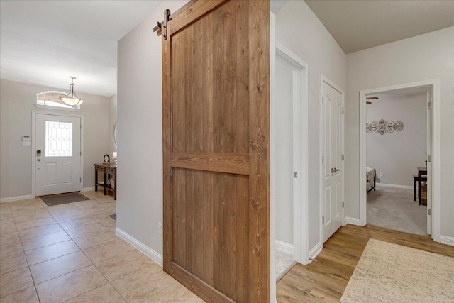 167 Limestone Trl Unit 76, Austin, TX 78737 - entryway featuring a barn door and baseboards