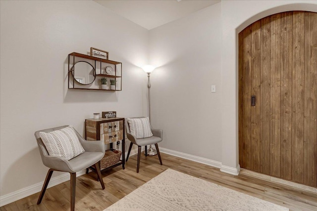167 Limestone Trl Unit 76, Austin, TX 78737 - living area with arched walkways, light wood-style flooring, and baseboards