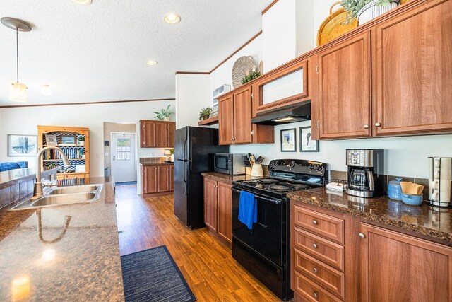 231 Wolf Run, Burnet, TX 78611 - kitchen featuring black appliances, a sink, under cabinet range hood, brown cabinetry, and ornamental molding