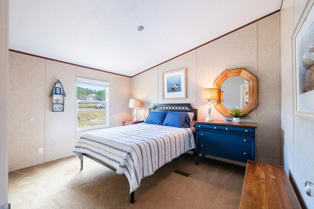 231 Wolf Run, Burnet, TX 78611 - carpeted bedroom featuring vaulted ceiling and ornamental molding