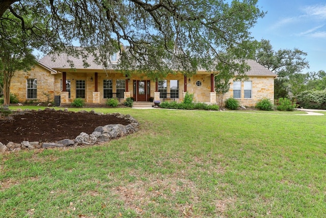 529 Honeycomb Cir, Driftwood, TX 78619 - single story home with stone siding, a front yard, and a porch