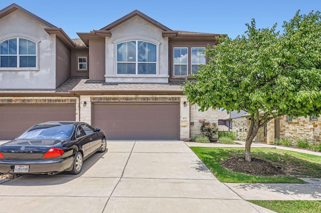 406 Epiphany Ln, Pflugerville, TX 78660 - multi unit property with an attached garage, stucco siding, driveway, and stone siding
