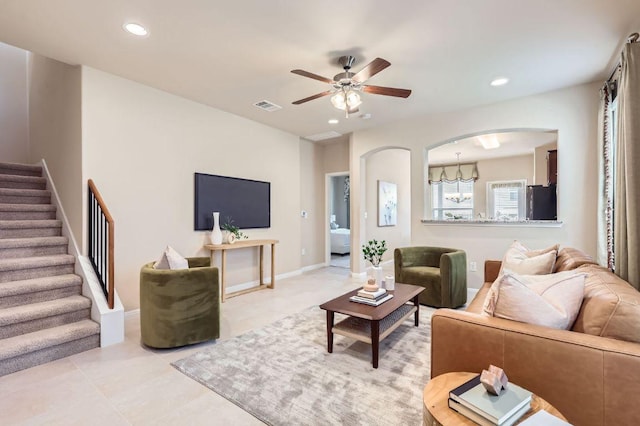 406 Epiphany Ln, Pflugerville, TX 78660 - living room featuring stairs, recessed lighting, a ceiling fan, light tile patterned floors, and arched walkways