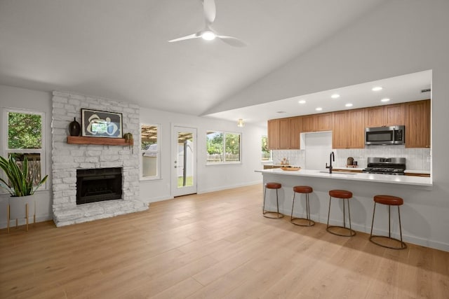 12303 Turtleback Ln, Austin, TX 78727 - kitchen with stainless steel appliances, light countertops, tasteful backsplash, ceiling fan, and vaulted ceiling