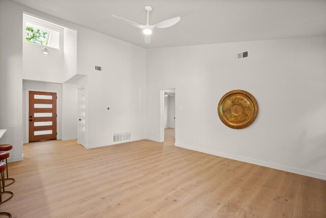 12303 Turtleback Ln, Austin, TX 78727 - living area featuring ceiling fan, light wood-style floors, and a towering ceiling