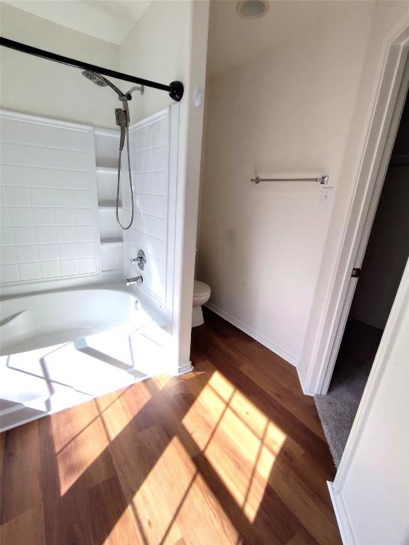 2108 Cottontail Dr, Leander, TX 78641 - bathroom with bathing tub / shower combination and wood finished floors