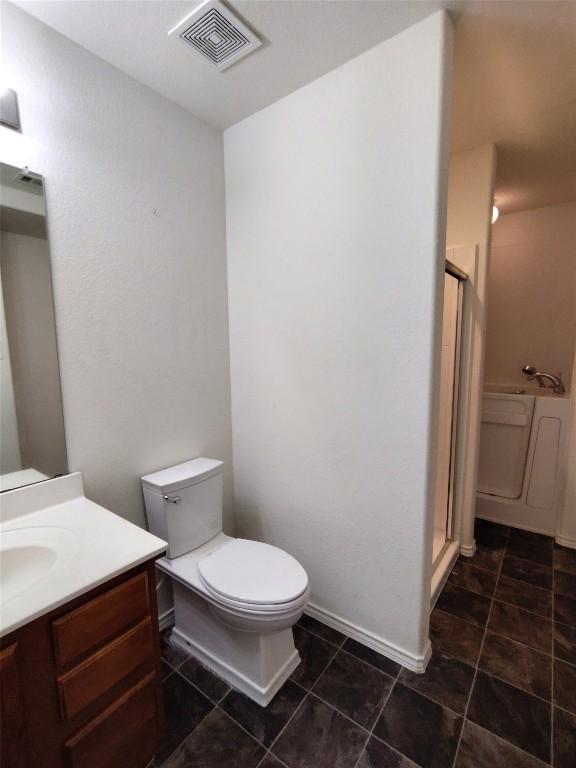 2108 Cottontail Dr, Leander, TX 78641 - full bathroom featuring vanity, a stall shower, toilet, tile patterned floors, and baseboards