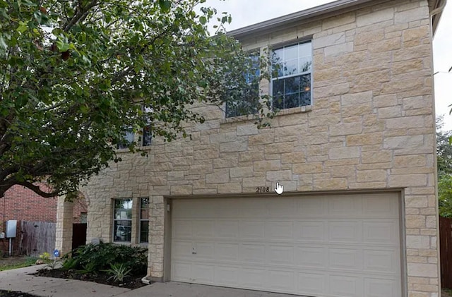 2108 Cottontail Dr, Leander, TX 78641 - view of front of house with a garage, stone siding, and concrete driveway