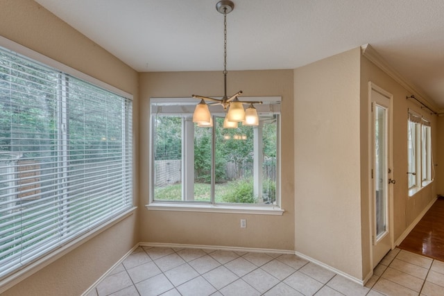 6429 Clay Allison Pass, Austin, TX 78749 - unfurnished dining area featuring plenty of natural light, a chandelier, light tile patterned floors, and baseboards