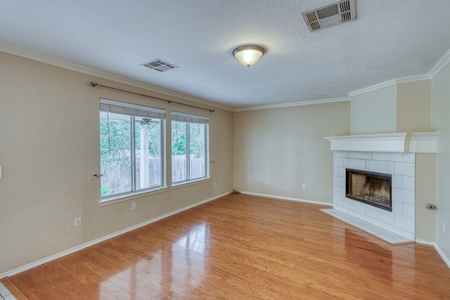 6429 Clay Allison Pass, Austin, TX 78749 - unfurnished living room featuring wood finished floors, ornamental molding, a fireplace, baseboards, and a textured ceiling