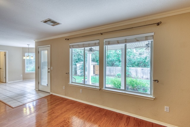 6429 Clay Allison Pass, Austin, TX 78749 - spare room featuring a chandelier, light wood-type flooring, crown molding, and baseboards