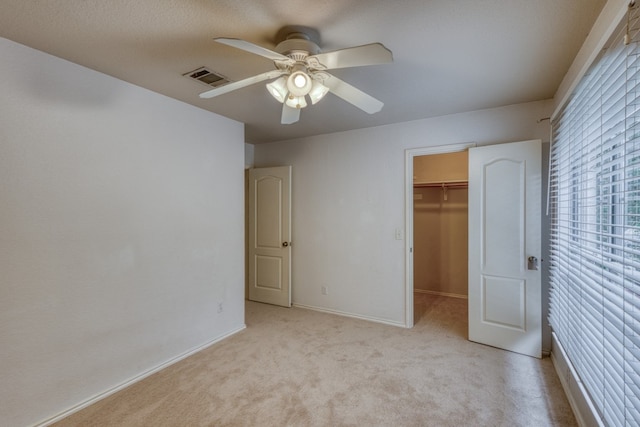6429 Clay Allison Pass, Austin, TX 78749 - unfurnished bedroom featuring a spacious closet, light carpet, baseboards, a ceiling fan, and a closet
