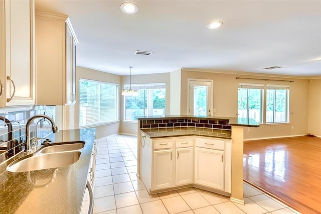 6429 Clay Allison Pass, Austin, TX 78749 - kitchen with healthy amount of natural light, open floor plan, recessed lighting, pendant lighting, and light tile patterned floors