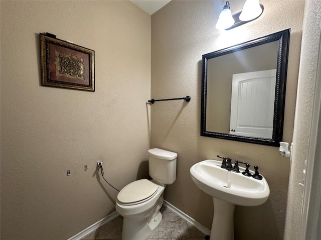 12400 Britannic Dr, Austin, TX 78753 - bathroom with toilet, baseboards, and tile patterned floors