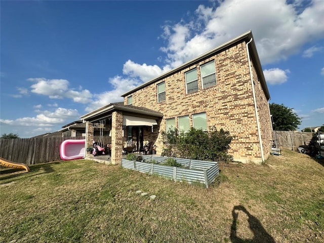 12400 Britannic Dr, Austin, TX 78753 - rear view of house with a garden and brick siding