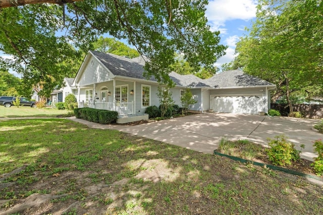 6008 Woodview Ave, Austin, TX 78757 - view of front facade with covered porch, an attached garage, a front yard, concrete driveway, and roof with shingles