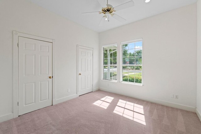 6008 Woodview Ave, Austin, TX 78757 - unfurnished bedroom featuring carpet flooring, baseboards, and ceiling fan