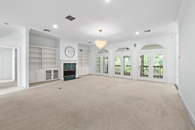 6008 Woodview Ave, Austin, TX 78757 - unfurnished living room featuring crown molding, light carpet, a premium fireplace, baseboards, and a chandelier