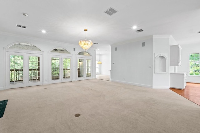 6008 Woodview Ave, Austin, TX 78757 - unfurnished living room featuring ornamental molding, light carpet, a chandelier, baseboards, and recessed lighting