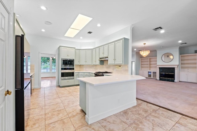 6008 Woodview Ave, Austin, TX 78757 - kitchen featuring appliances with stainless steel finishes, a peninsula, light carpet, recessed lighting, and light tile patterned flooring