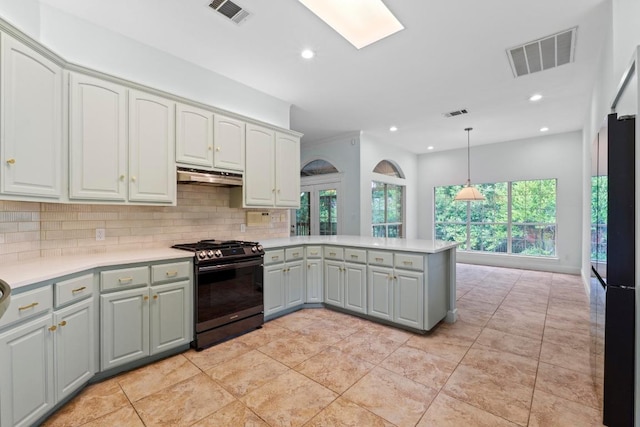 6008 Woodview Ave, Austin, TX 78757 - kitchen with stainless steel range with gas cooktop, under cabinet range hood, a peninsula, freestanding refrigerator, and gray cabinetry