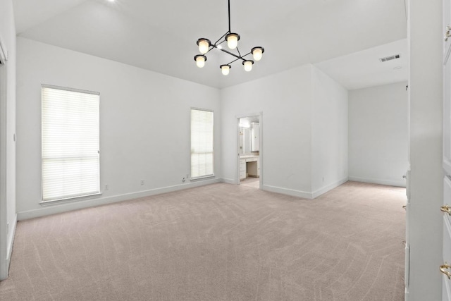 6008 Woodview Ave, Austin, TX 78757 - empty room featuring light colored carpet, baseboards, and a chandelier