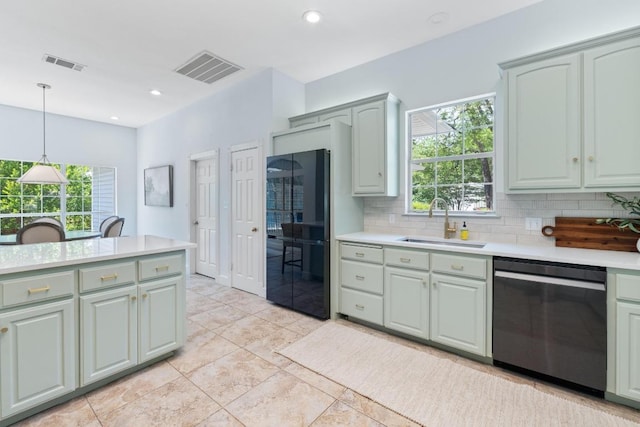 6008 Woodview Ave, Austin, TX 78757 - kitchen with dishwasher, freestanding refrigerator, light countertops, decorative backsplash, and pendant lighting