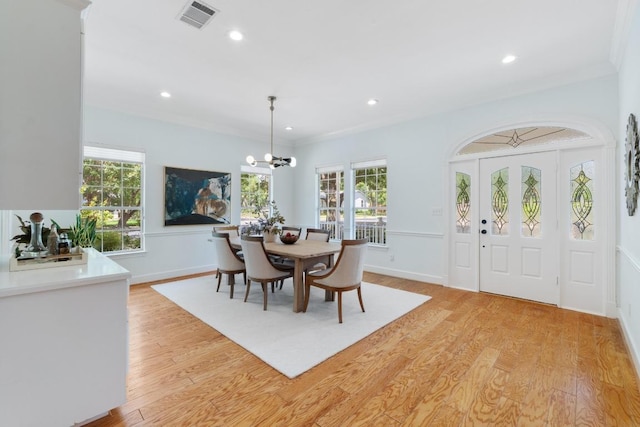 6008 Woodview Ave, Austin, TX 78757 - dining area featuring a chandelier, light wood finished floors, healthy amount of natural light, recessed lighting, and ornamental molding