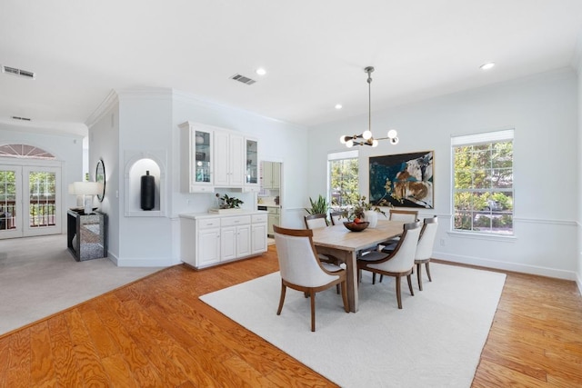 6008 Woodview Ave, Austin, TX 78757 - dining room with a chandelier, light wood finished floors, recessed lighting, french doors, and crown molding